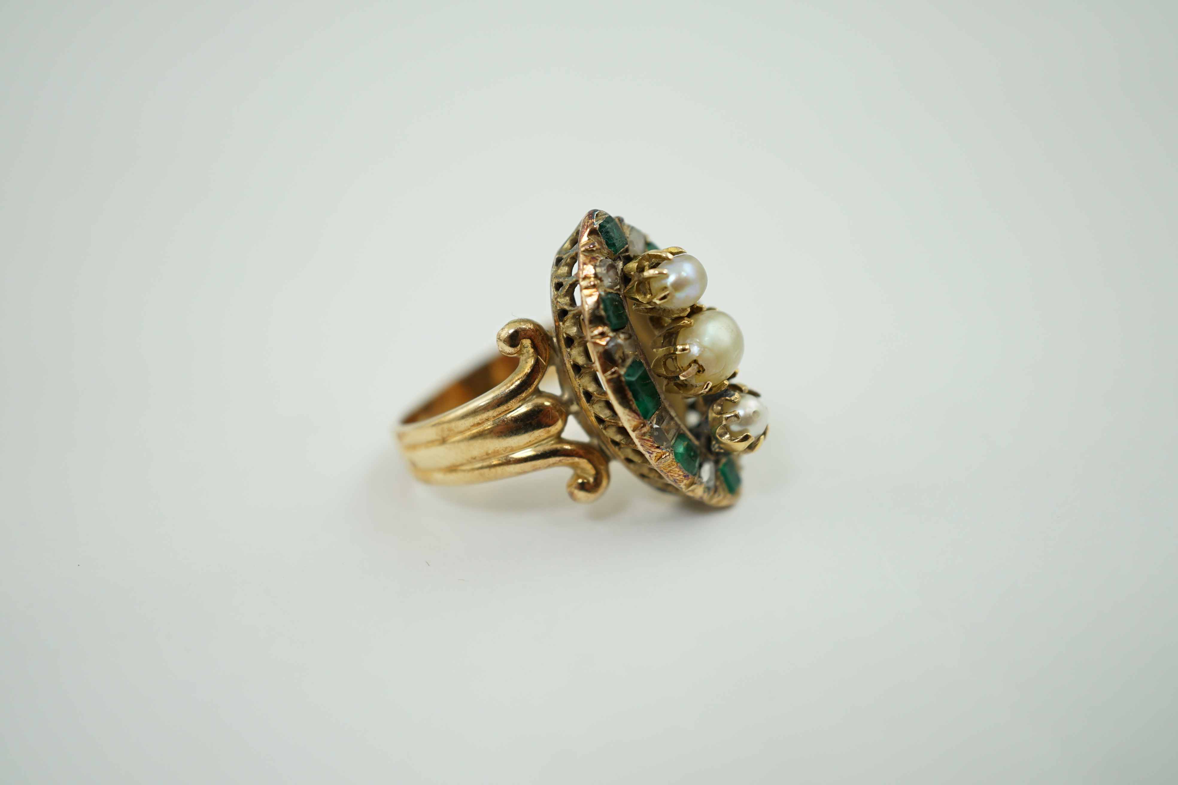 An antique gold, button pearl, emerald and diamond set navette shaped cluster ring